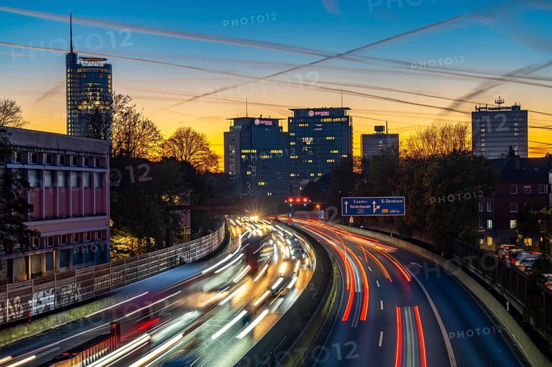 Evening traffic, partly with traffic jams, slow-moving traffic on the A40 motorway, skyline of Essen, RWE tower on the left, Evonik Group headquarters in the middle, former Postbank building on the right, Essen, North Rhine-Westphalia, Germany, Europe