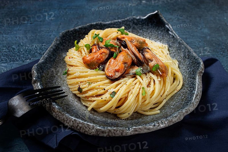 Spaghetti with mussels, without shell, pasta with peeled mussels, in carbonara sauce, micro-greens, homemade, no people