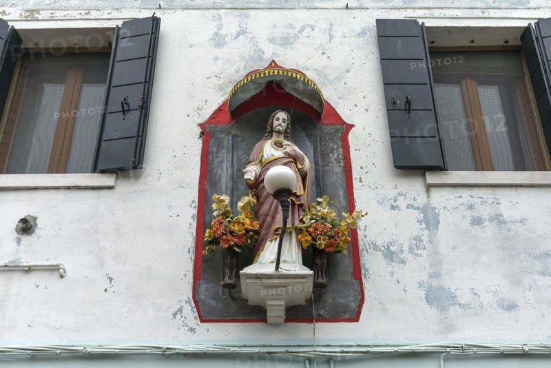Christ figure with canopy on a house, Burano, Venice, Veneto, Italy, Europe