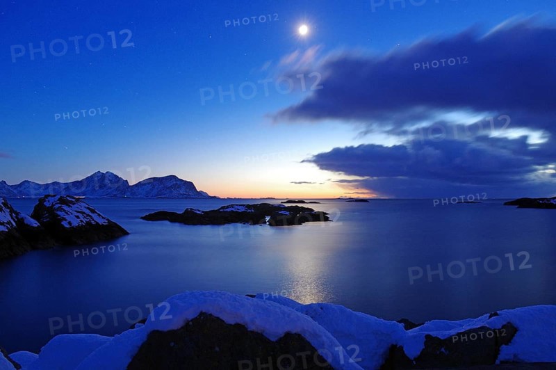 Winter coastal landscape at dusk with snow-covered islands, clear sky and moon, Nyksund, Langoya, Vesteralen, Nordland, Norway, Europe