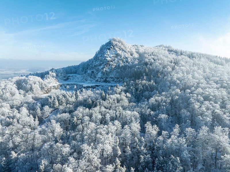 Aerial view of the snow-covered Hegau volcano Hohenstoffeln, with the former basalt quarry, surrounded by frosty trees in a winter landscape, district of Constance, Baden-Württemberg, Germany, Europe
