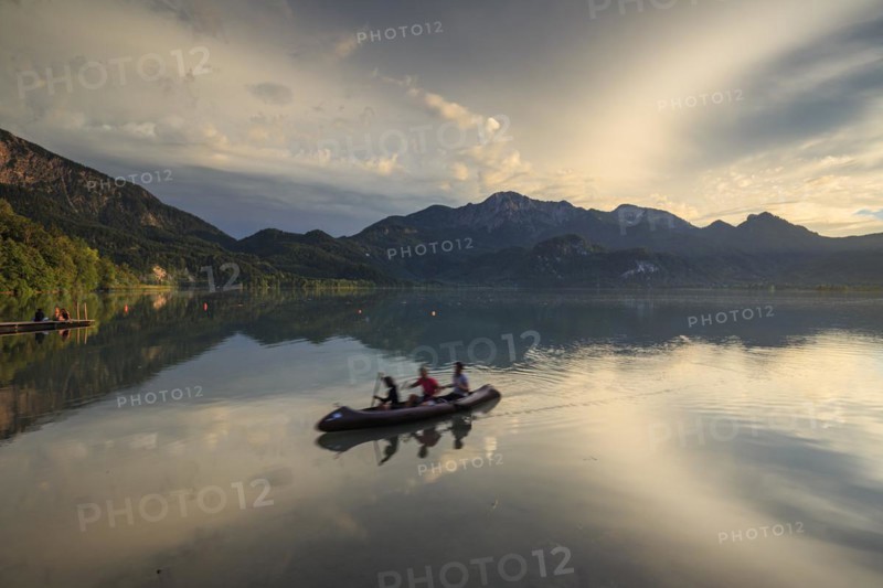 Canoeist on lake in front of mountains, stormy mood, reflection, Lake Kochel, Alpine foothills, Bavaria, Germany, Europe