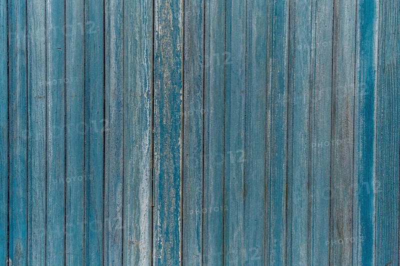 Garage door boards stained blue with worn paint. Brittany France