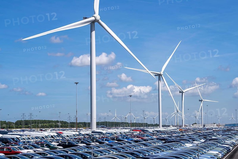 Storage area for new cars in the port of Vlissingen-Oost, vehicles are temporarily stored on over 100 hectares to ship them from Europe to the United Kingdom, Ford cars, others such as models from the Chinese car manufacturer BYD are delivered from here in Europe, wind farm, Netherlands