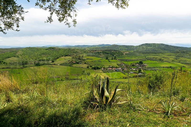 View south east from Apollonia over fields, countryside, hills, village of Kryegjatë, Fier County, Albania, Europe