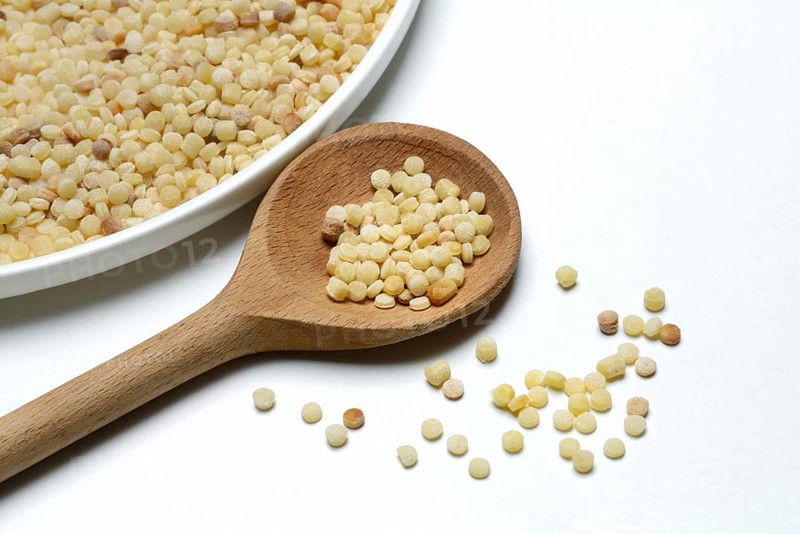Fregola in wooden spoon, pasta variety from Sardinia, Italy, Europe