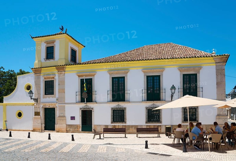 Colonial-style building with yellow accents, outdoor seating under parasols, Consulado-Geral do Brasil, Consulate General of Brazil, Faro, Algarve, Portugal, Europe