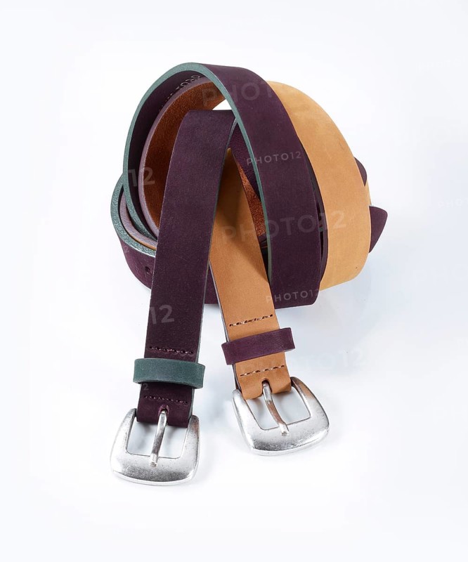 Leather belt in front of a white background, studio shot