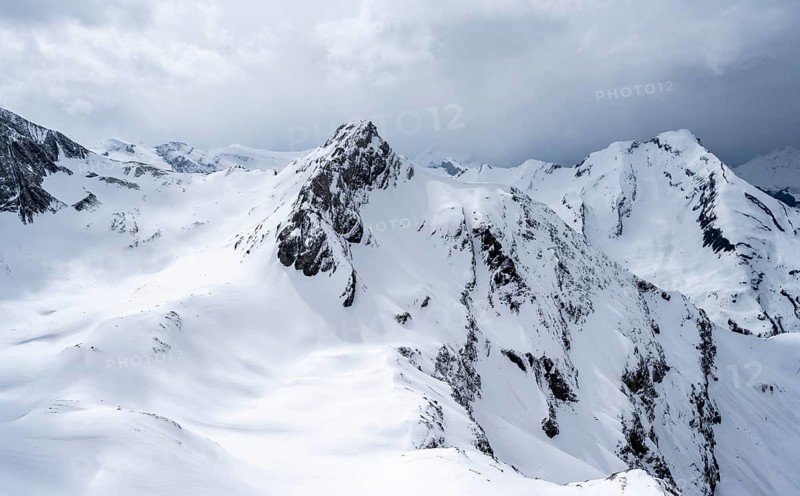 Snow-covered mountain landscape, Wildhorn peak in the background, dramatic clouds, Bernese Alps, Bernese Oberland, Switzerland, Europe