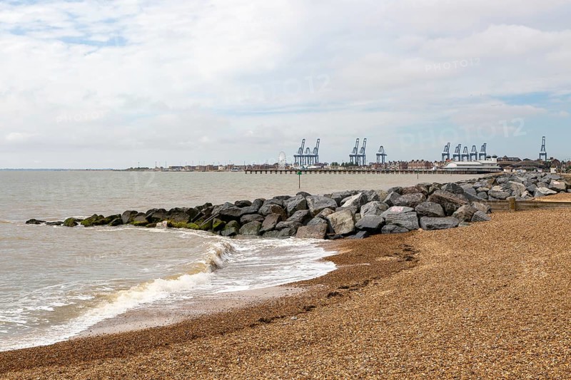 Rock armour groynes on beach managing longshore drift, Felixstowe, Suffolk, England, UK
