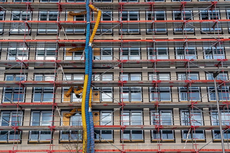 Large construction site, scaffolded shell of an office building complex, air hoses for building ventilation, heating, O-Werk Campus in Bochum, North Rhine-Westphalia, Germany, Europe