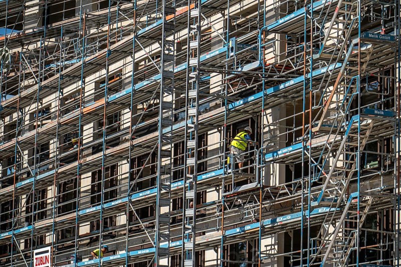 Construction site, at the Cologne Trade Fair Centre, new construction of a high-rise office building, construction cranes, facade of the shell, scaffolding, North Rhine-Westphalia, Germany, Europe