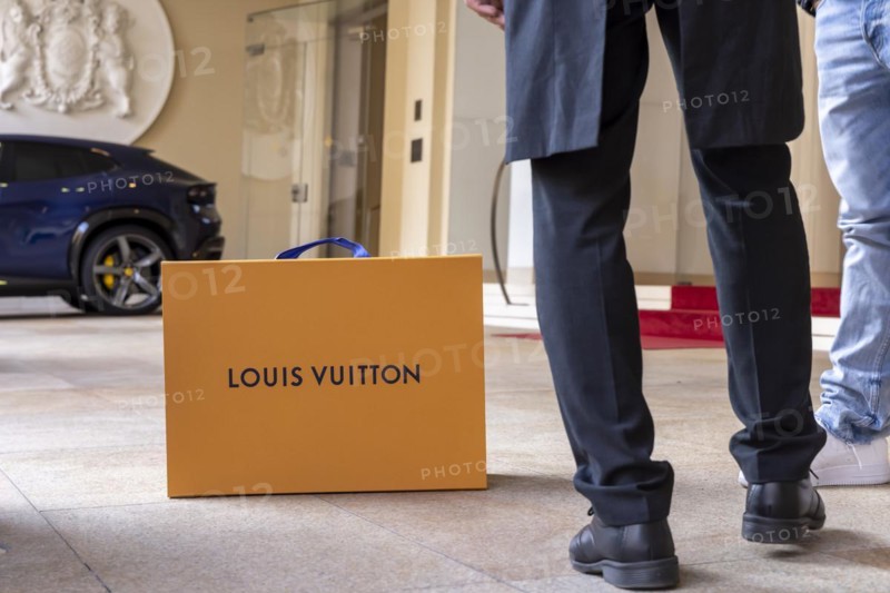 Shopping bag of the luxury brand Louis Vuitton, Hotel Vier Jahreszeiten Kempinski Munich with red carpet, Munich, Bavaria, Germany, Europe