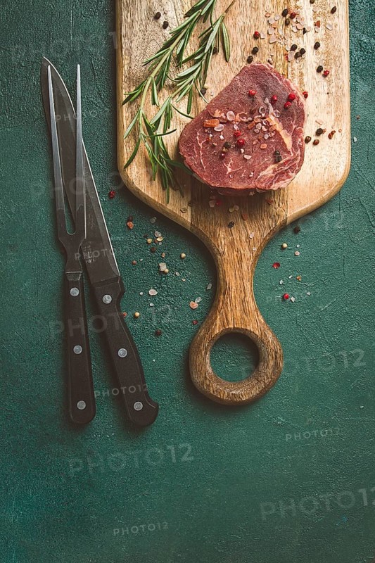 Fresh, raw rib eye steak, on a chopping board, top view, no people
