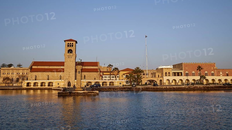 Church at the harbour, surrounded by calm sea and clear blue sky at morning light, Church of the Annunciation of the Blessed Virgin Mary, bell tower, harbour area, Rhodes Town, Rhodes, Dodecanese, Greek Islands, Greece, Europe