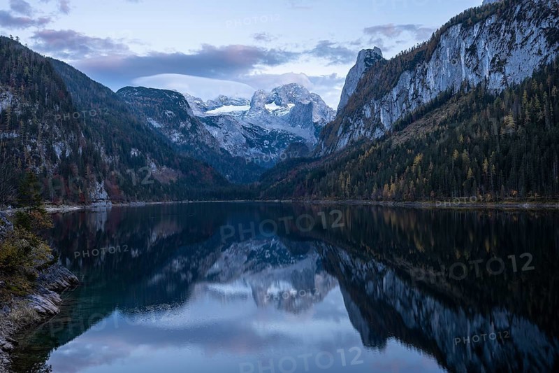 The Vordere Gosausee lake in autumn with a view of the Dachstein mountain range. The Gosaukamm on the right. Good weather, blue sky. Few clouds. In the evening, after sunset. Reflection. Vorderer Gosausee, Gosau, Gosau valley, Salzkammergut, Upper Austria, Austria, Europe