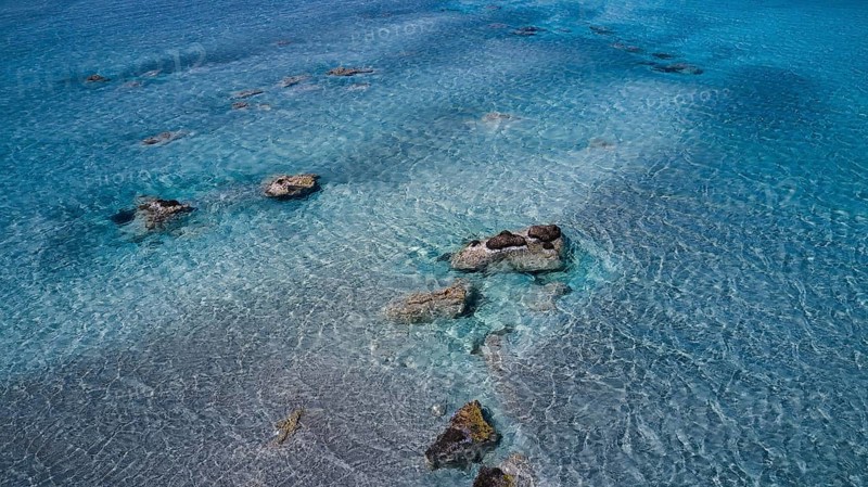 Crystal-clear sea water with visible stones and a calm atmosphere, Elafonissi, lagoon, south-west tip of Crete, Crete, Greek islands, Greece, Europe