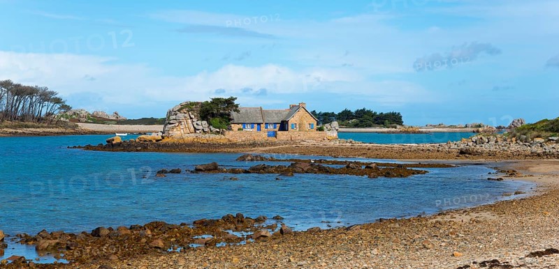 A stone house on a small island surrounded by calm water and rocks, house on the Plage de Raluzet, Plougrescant, Côtes-d'Armor, English Channel, Brittany, France, Europe