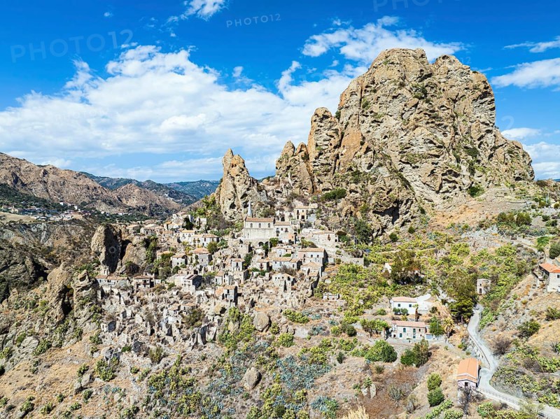 Mountains and Olive groves around Ghost Town from a drone, Pentedattilo Village, Calabria, Italy, Europe
