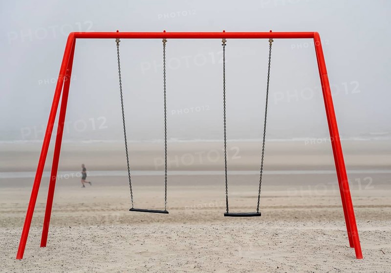 North Sea island of Langeoog, early summer, shortly after the first easing of the lockdown in the Corona crisis, foggy weather, still quite few tourists on the beach, children's swing, Lower Saxony, Germany, Europe