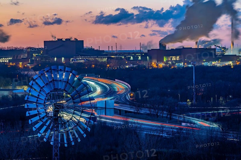 Skyline of the steel location Duisburg, Thyssenkrupp Steel Europe, in Duisburg-Bruckhausen, sunset, industrial scenery, North Rhine-Westphalia, Germany motorway A42, Emscher expressway, coking plant Schwelgern, extinguishing cloud, discharge cloud, water vapour, wind turbine of the landscape park Duisburg Nord