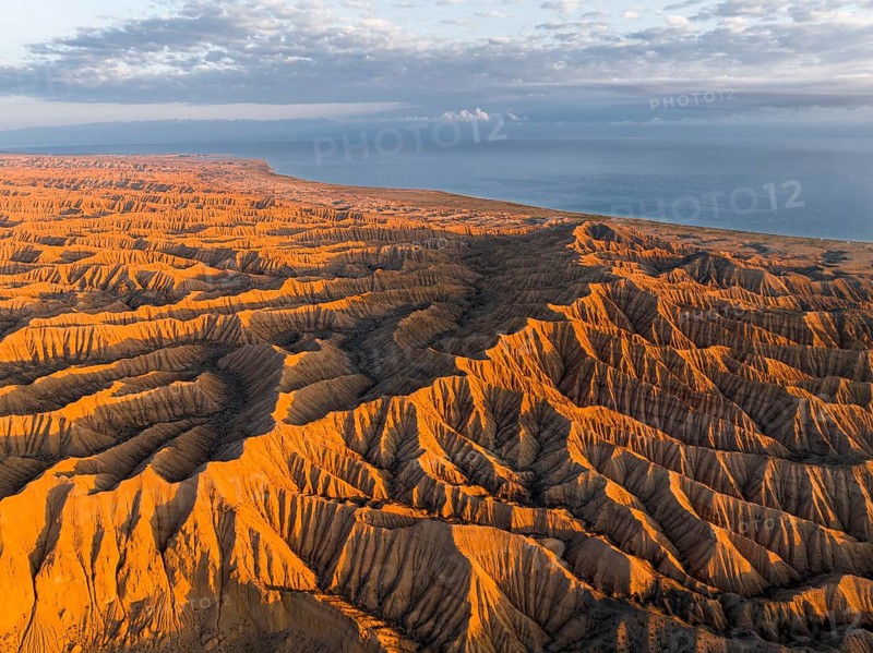 Landscape of eroded hills at Lake Issyk Kul, Badlands at sunrise, aerial view, Canyon of the Forgotten Rivers, Issyk Kul, Kyrgyzstan, Asia