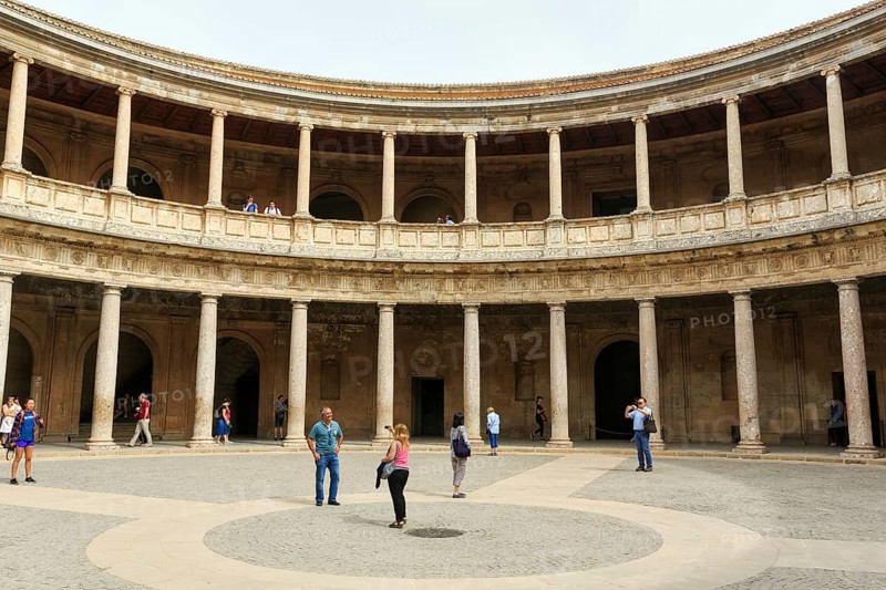 Palacio de Carlos V, Palace of Charles V, Renaissance palace in the Alhambra, gallery with columns made of conglomerate stone, tourists in the inner courtyard, Granada, Andalusia, Spain, Europe