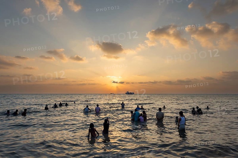 Hindu pilgrims take a holy dip in the sea at sunrise at Ghat Agni Theertham, Rameswaram or Rameshwaram, Pamban Island, Tamil Nadu, India, Asia