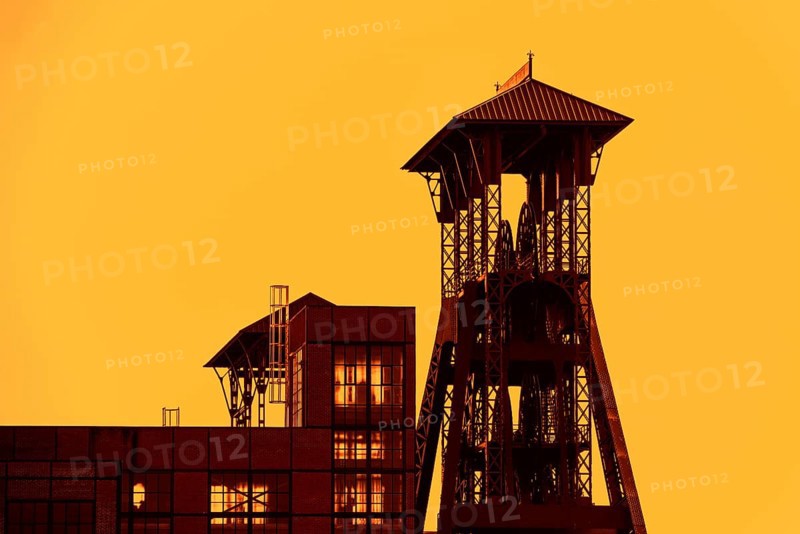 Colliery headframe, hoist frame and coal mine building in the coal mining town Beringen at sunset, Koersel, province of Limburg, Flanders, Belgium, Europe