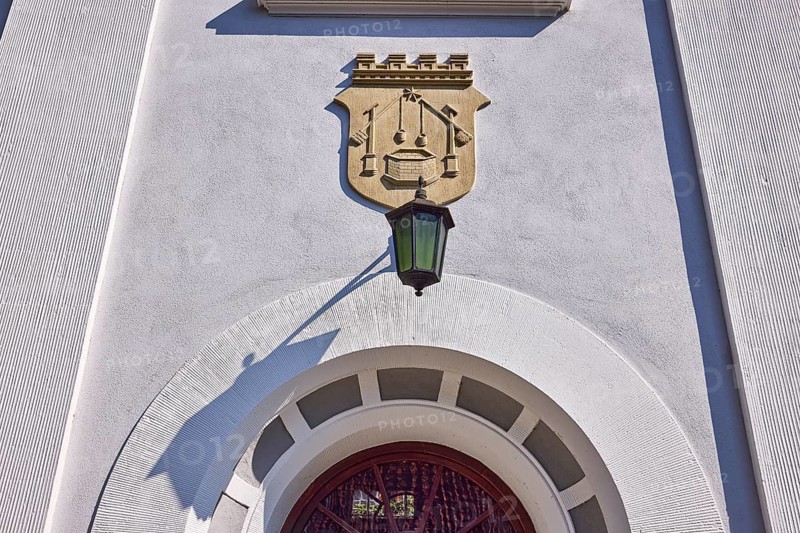 Facade of a house in the classicist style with the coat of arms of the salt boiling trade and lantern in Bad Salzuflen, Lippe district, North Rhine-Westphalia, Germany, Europe