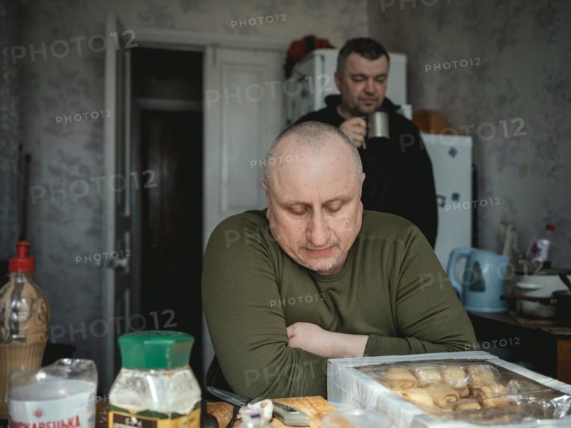Gennady, 48, and a comrade in the kitchen of the house where his unit has taken up position, Kupyansk is beset by Russian attacks, Kupyansk, Kharkiv oblast, Ukraine, Europe