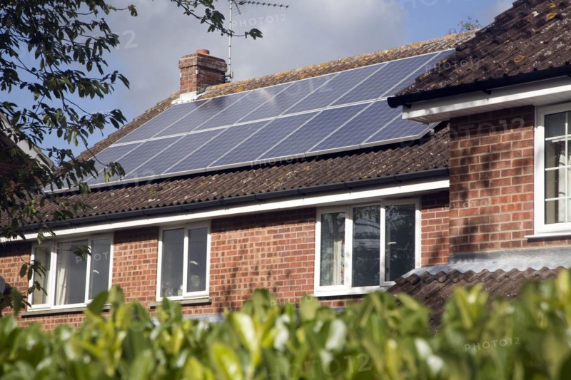 Large array of solar panels on domestic house roof