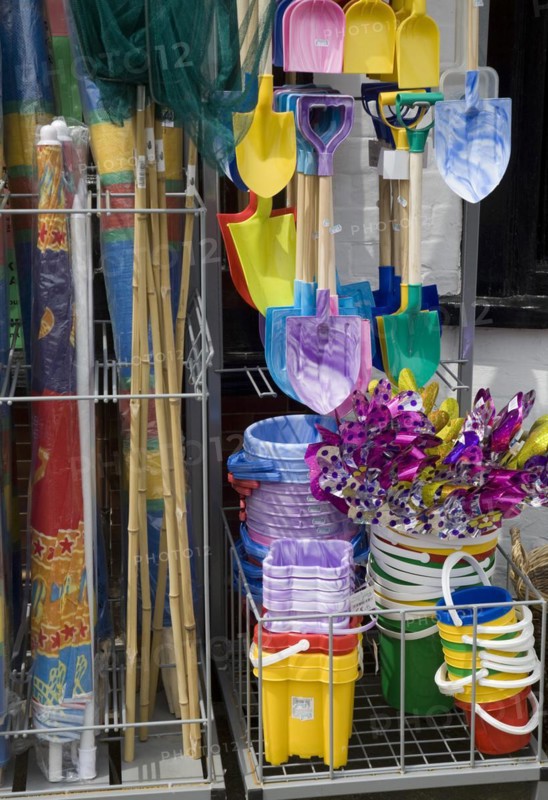 Traditional seaside buckets and spades on sale outside a shop in Aldeburgh, Suffolk, England, United Kingdom, Europe