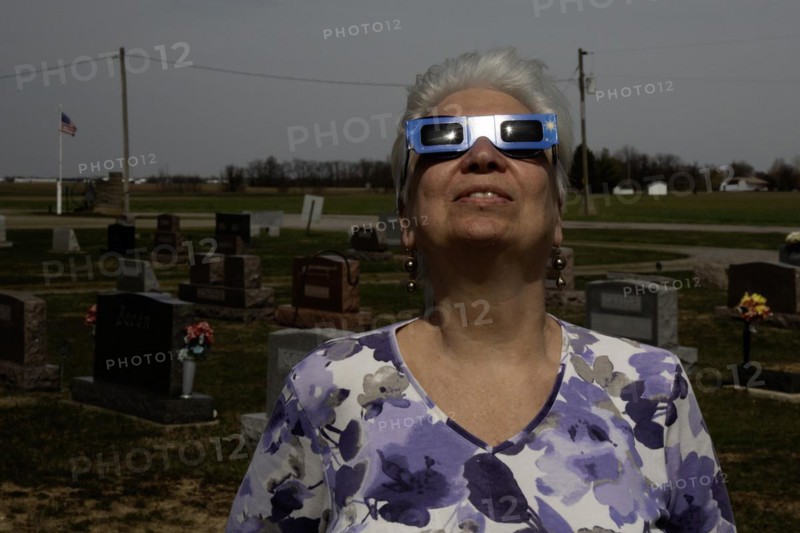 Van Wert, Ohio USA, 8 April 2024, A total solar eclipse, seen from northwestern Ohio. Susan Newell used her eclipse glasses to safely view the sun from the Mt. Pleasant Cemetery