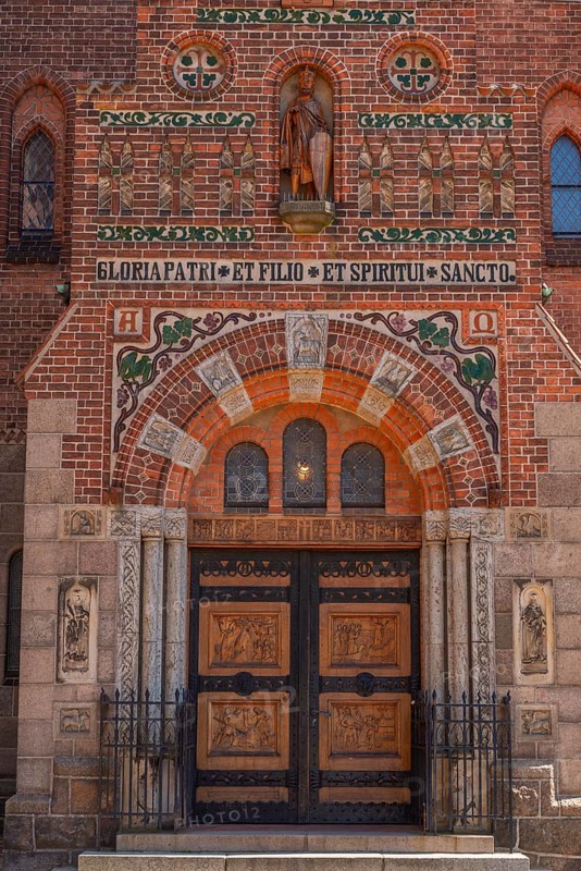 Odense, early Gothic St Albani Church, Roman Catholic church, entrance portal with wood carvings, brick building, Latin inscription, statues, Fyn, Fyn Island, Denmark, Europe