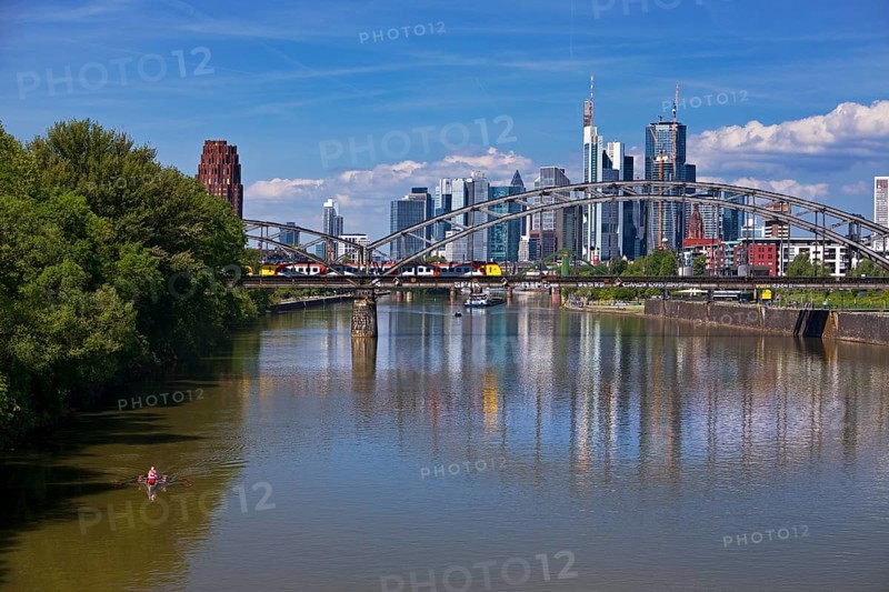 The river Main with regional railway on the Deutschherrnbrücke and the skyline of Frankfurt am Main, Hesse, Germany, Europe