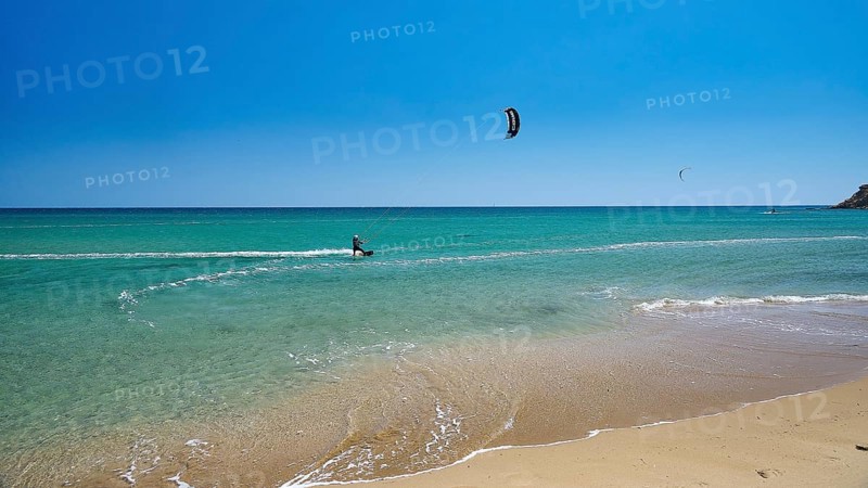Kitesurfer rides on calm turquoise sea near the beach, surfer's paradise, kitesurfer, windsurfer, Prasonisi, island in the south of Rhodes, Rhodes, Dodecanese, Greek Islands, Greece, Europe