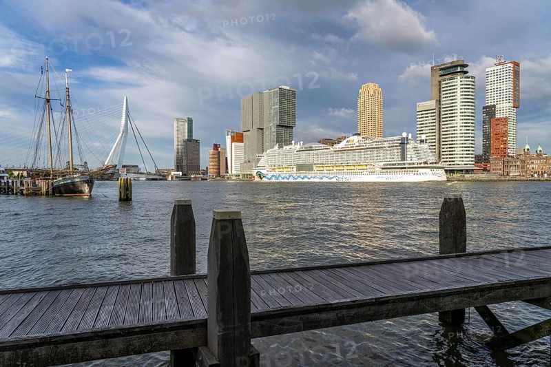 Rotterdam, skyline at the Nieuwe Maas, Erasmus Bridge, skyscrapers at the Kop van Zuid district, cruise ship Aida Prima at the Cruise Terminal, Veerhaven, historic ships, sailing boats, pier, Netherlands