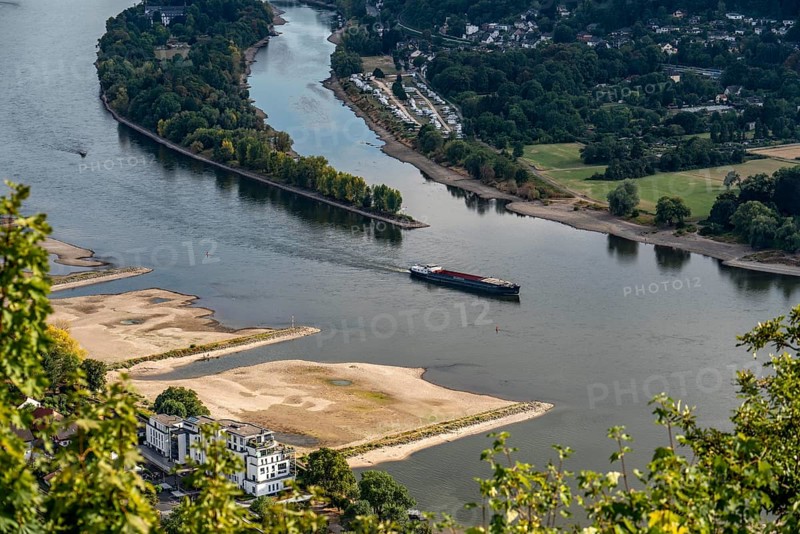 The Rhine at extremely low water, near Bad Honnef, below the Drachenfels, Nonnenwerth Island, dry Rhine banks, cargo ship, descent, with very reduced cargo, North Rhine-Westphalia, Germany, Europe