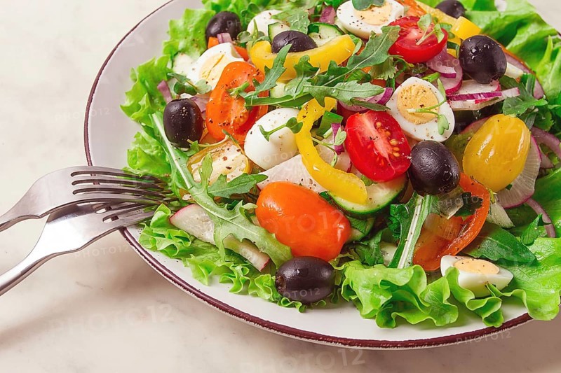 Vegetable salad, with quail eggs and olives, fresh, close-up, no people