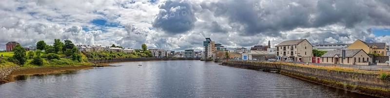 Panoramic view of a town along a river under a cloudy sky, Sligo