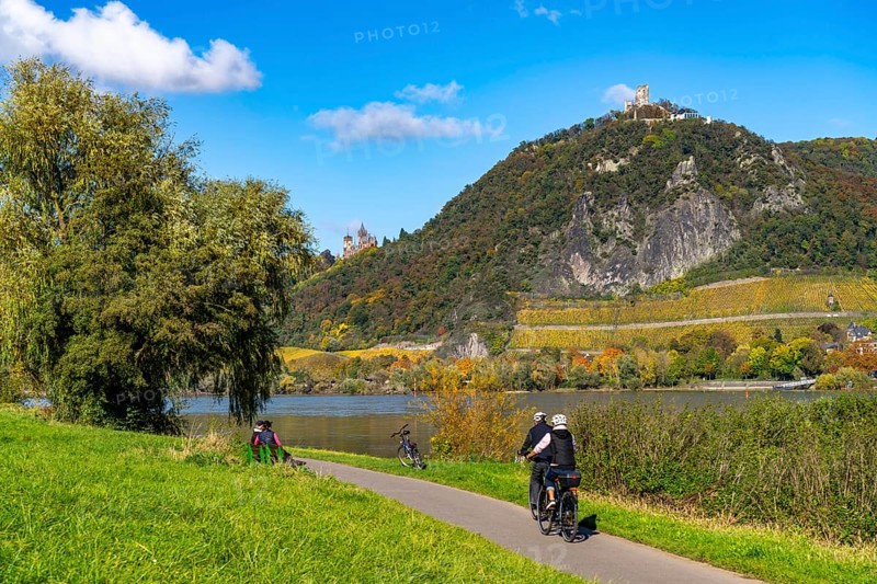 Cycle path on the Drachenfels, a mountain in the Siebengebirge on the Rhine between Bad Honnef and Königswinter, with Drachenfels castle ruins and Drachenburg castle, left, boat traffic on the Rhine, North Rhine-Westphalia, Germany, Europe