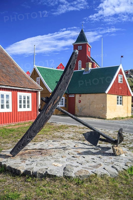 Historic building and anchor in front of blue sky, Museum, Sisimiut, West Greenland, Greenland, North America