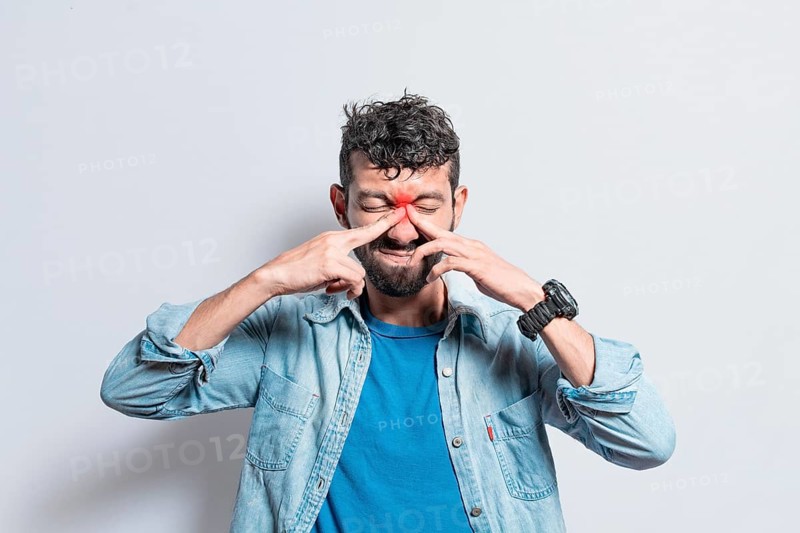 Man with nasal bridge headache, person with pain touching nose. sinus pain concept, A person with nasal bridge pain