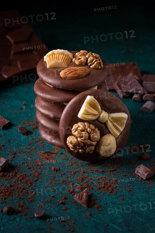 A stack of chocolate mediants, handmade candies, on a dark background, in the style of dark food, selective focus, vertical