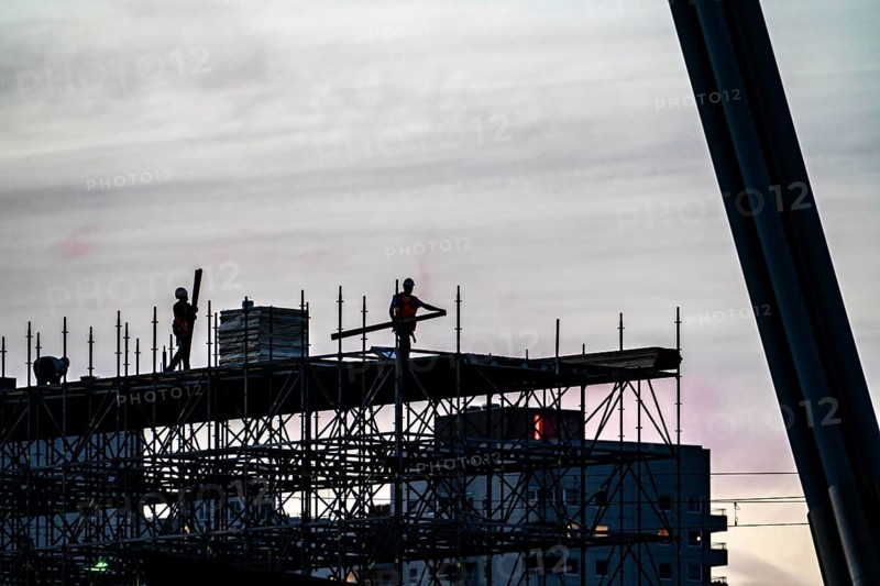 Workers dismantle scaffolding on the Erasmus Bridge over the Nieuwe Maas in Rotterdam, Netherlands
