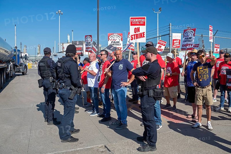 Detroit, Michigan USA, 5 September 2024, Police escort a truck through the picket line as members of the Teamsters Union are in the second day of a strike against the Marathon Petroleum refinery. The union has been working without a contract since January. The main issues are a wage increase to match the last four years' inflation and preserving benefits. Marathon has brought in replacement workers to keep the refinery operating