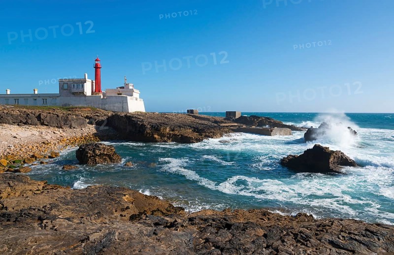 Lighthouse on the coast with rough waves and rocks under a blue sky, Farol do Cabo Raso, São Brás de Sanxete fortress, Estoril, Cascais, Parque Natural de Sintra-Cascais, Portugal, Europe