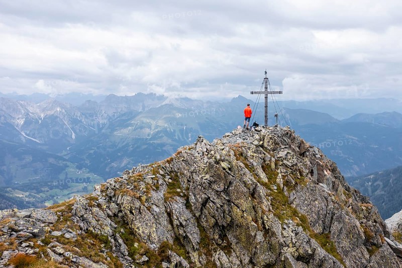 Aerial view, hiker on the Raudenspitze with summit cross, Carnic High Trail, Carnic Main Ridge, Carnic Alps, Carinthia, Austria, Europe