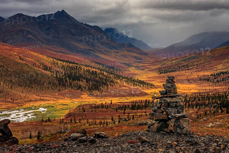 Autumn coloured tundra, mountains, clouds, Inukshuk, Tombstone Territorial Park, Dempster Highway, Yukon, Canada, North America